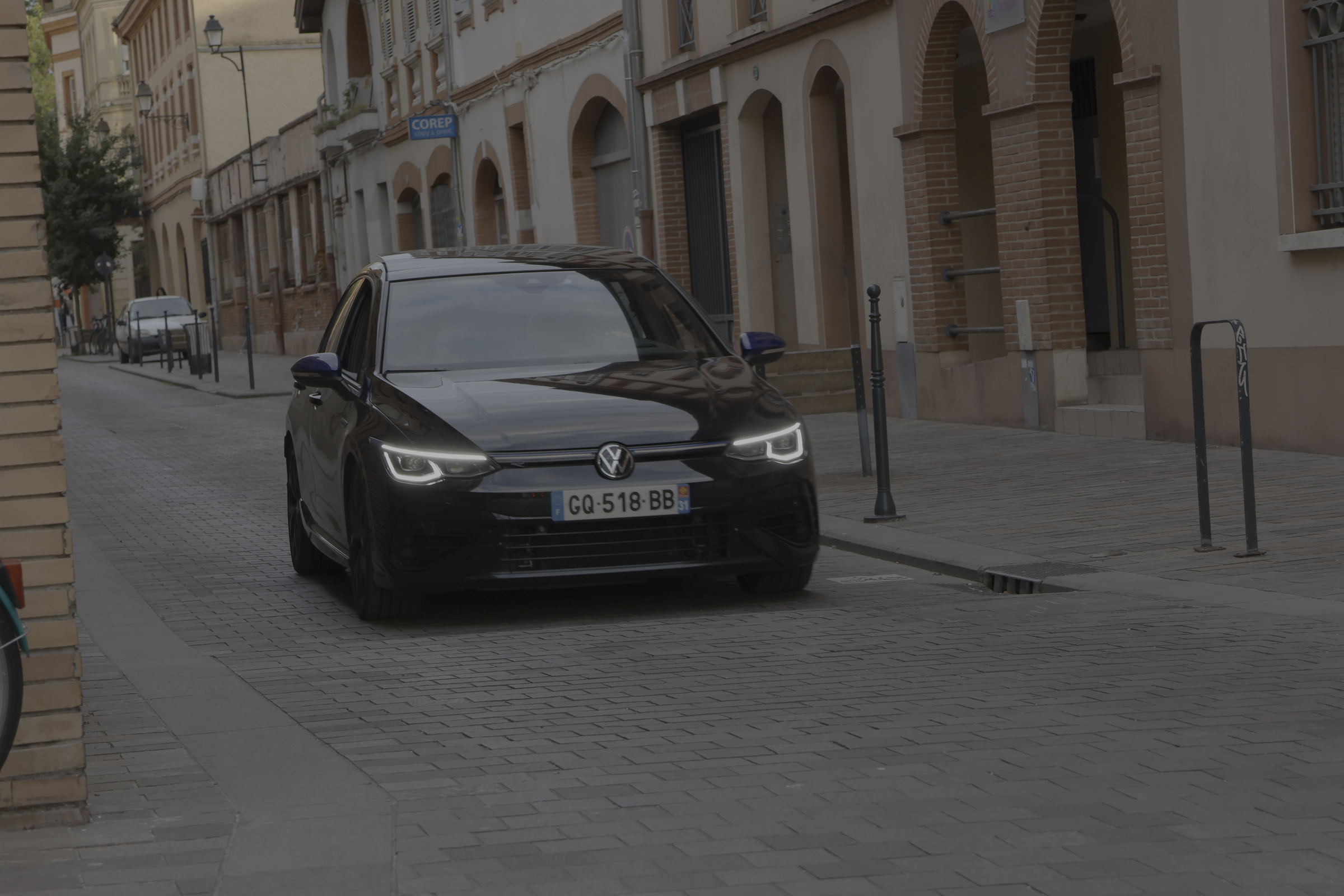 Automobile photographiée dans une rue bordée d’immeubles